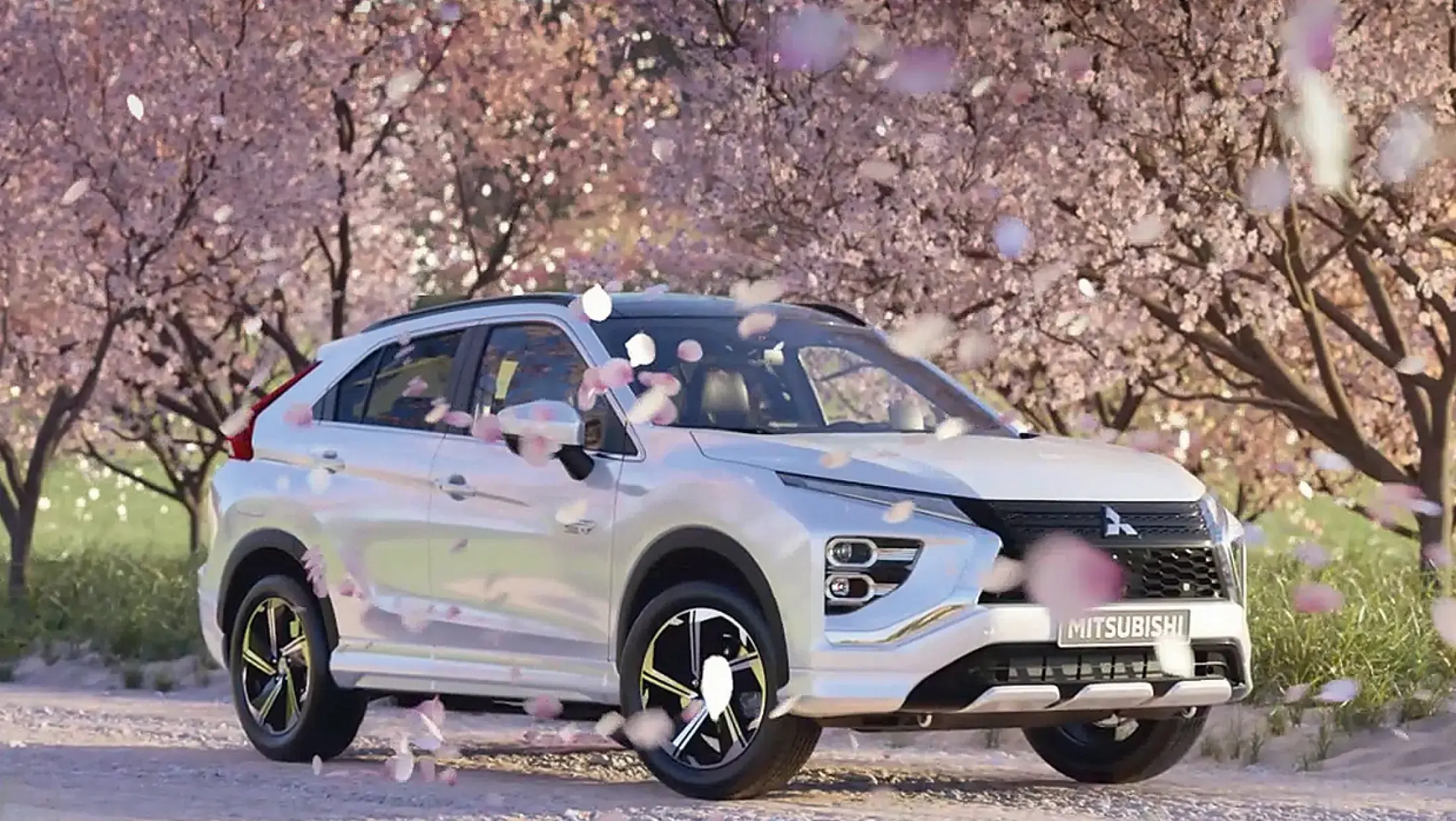 Mitsubishi Eclipse Cross PHEV met bloesem bomen op de achtergrond